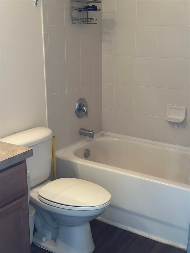 full bathroom with tiled shower / bath, vanity, toilet, and hardwood / wood-style flooring