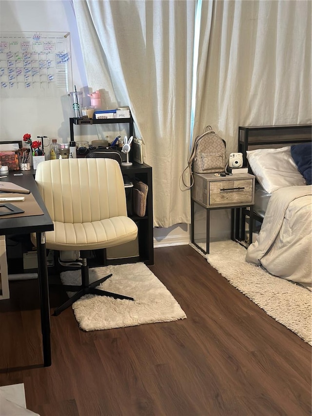 bedroom with dark hardwood / wood-style flooring