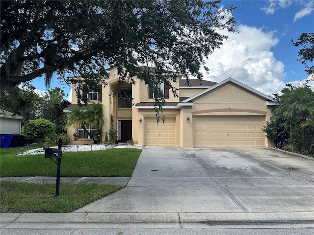 view of front of property featuring a front yard and a garage