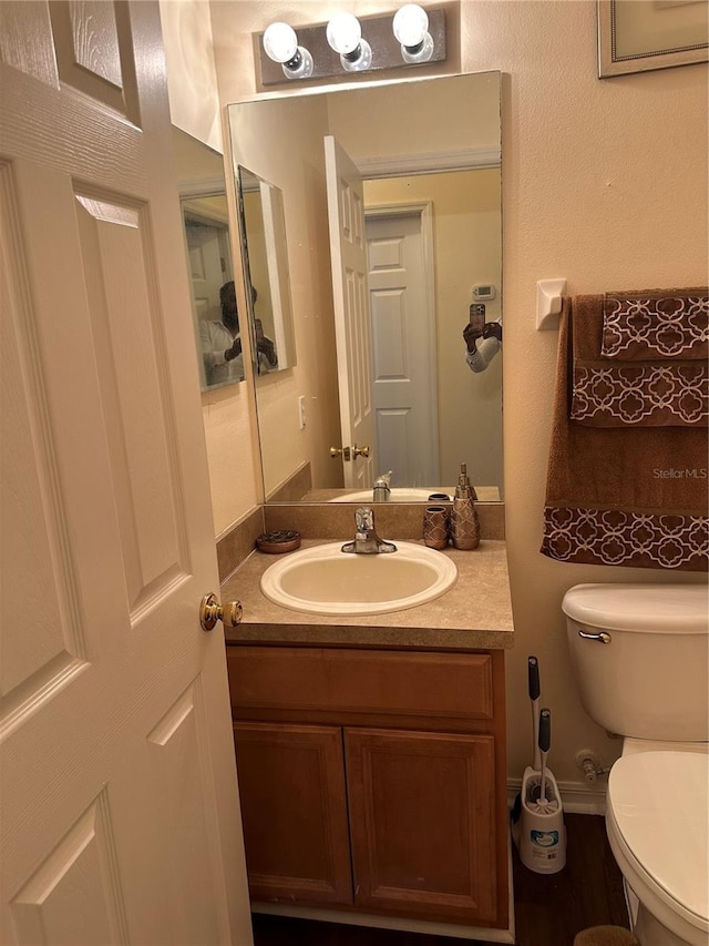 bathroom featuring vanity and toilet