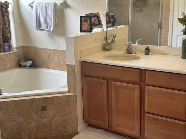 bathroom with vanity and tiled bath