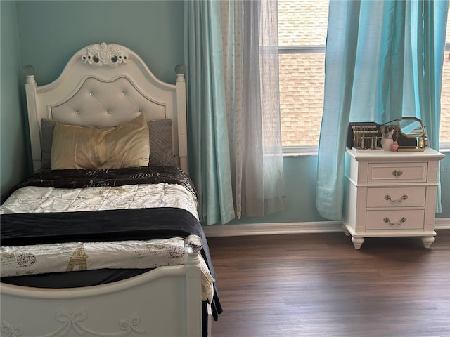 bedroom with dark wood-type flooring