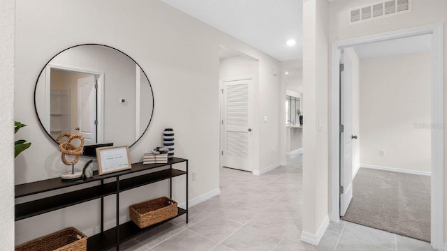 corridor featuring light tile patterned floors