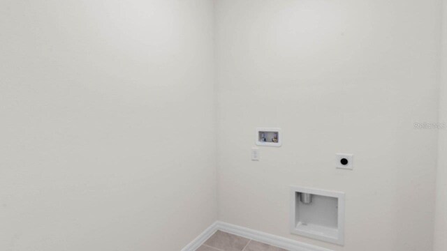 washroom featuring washer hookup, baseboards, laundry area, electric dryer hookup, and light tile patterned floors