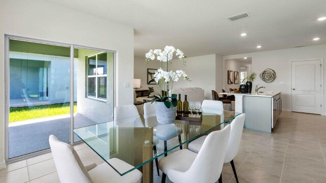 dining room with light tile patterned flooring, visible vents, and recessed lighting