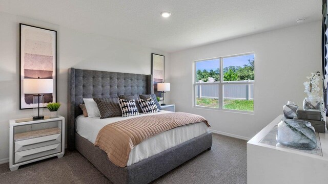 bedroom with baseboards, dark colored carpet, and a textured ceiling