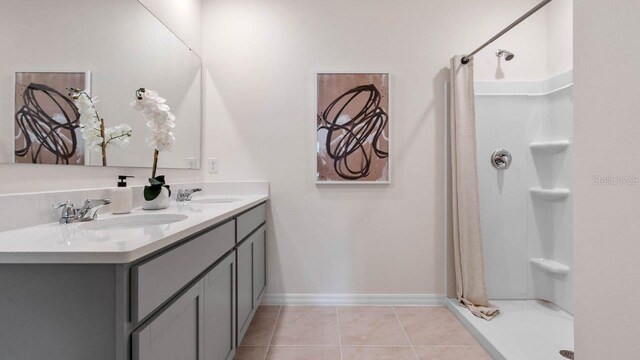bathroom featuring a sink, a stall shower, and tile patterned floors