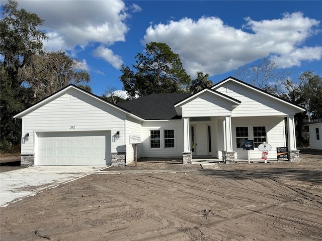 view of front of house featuring covered porch and a garage