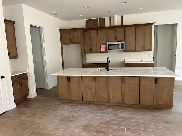 kitchen with sink and an island with sink