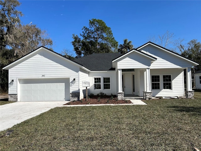 view of front facade with a garage and a front lawn