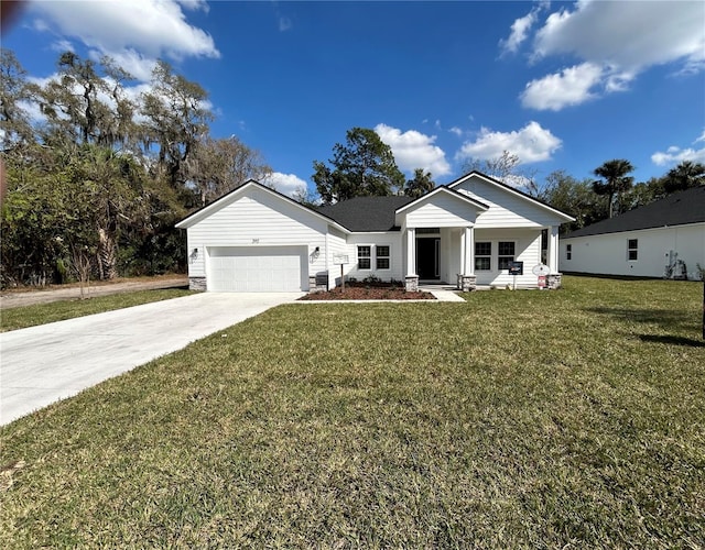 view of front of home with a garage, covered porch, and a front yard