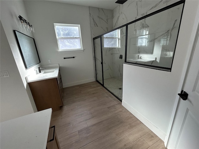 bathroom with a shower with door, vanity, and hardwood / wood-style floors