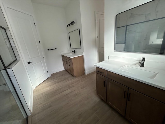 bathroom featuring vanity, wood-type flooring, and a shower