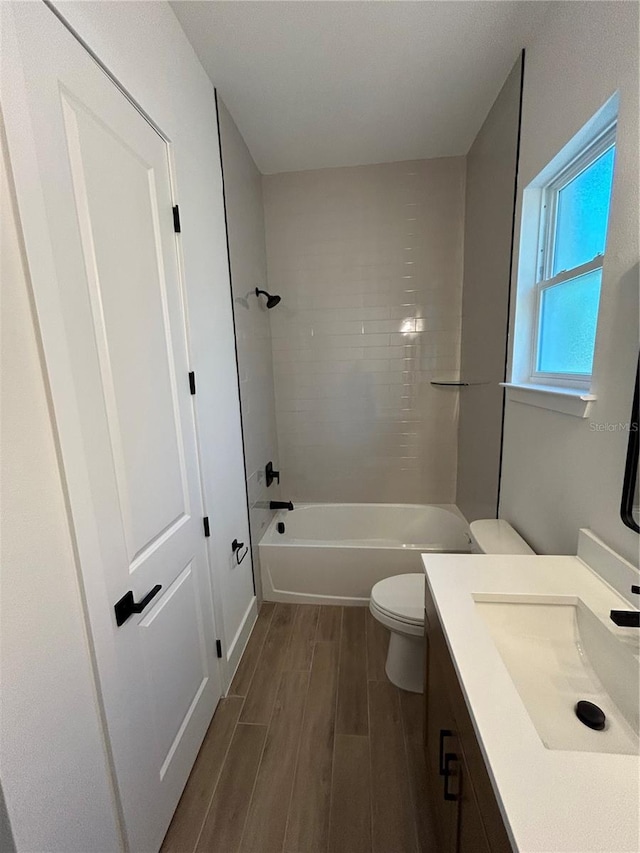 full bathroom featuring vanity, toilet, and tiled shower / bath combo