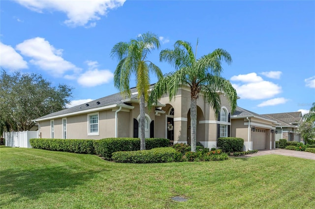 view of front of home with a garage and a front yard