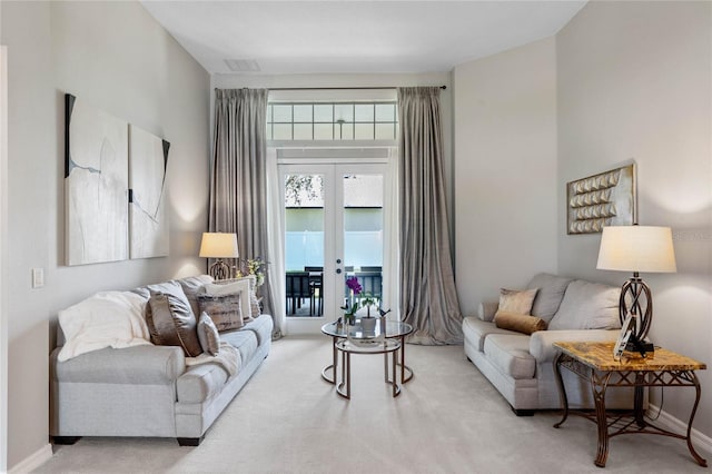 living room with french doors and light colored carpet