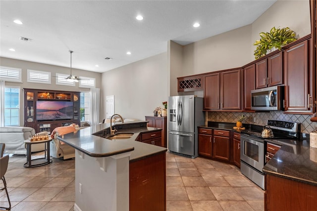 kitchen with a breakfast bar, sink, plenty of natural light, and appliances with stainless steel finishes