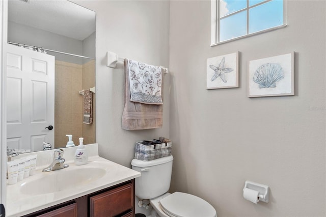 bathroom with vanity, toilet, and walk in shower