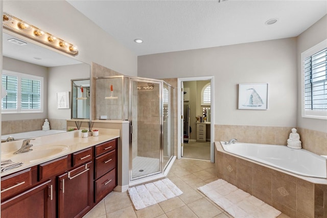 bathroom with tile patterned flooring, vanity, and independent shower and bath