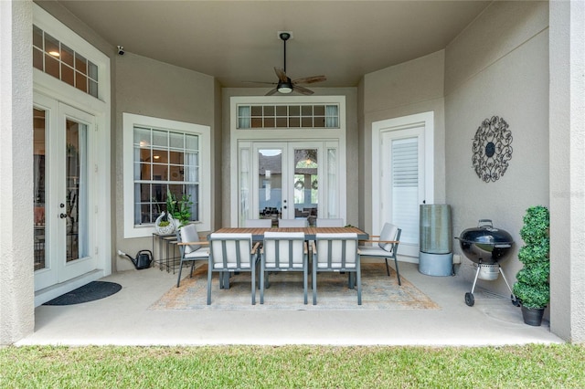 view of patio featuring ceiling fan, area for grilling, and french doors