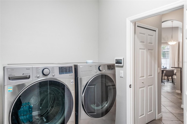 laundry area with tile patterned floors and washer and dryer