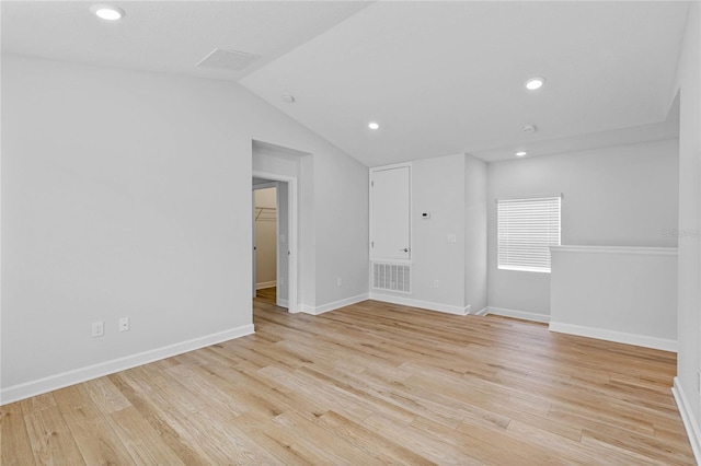 unfurnished room with lofted ceiling and light hardwood / wood-style floors