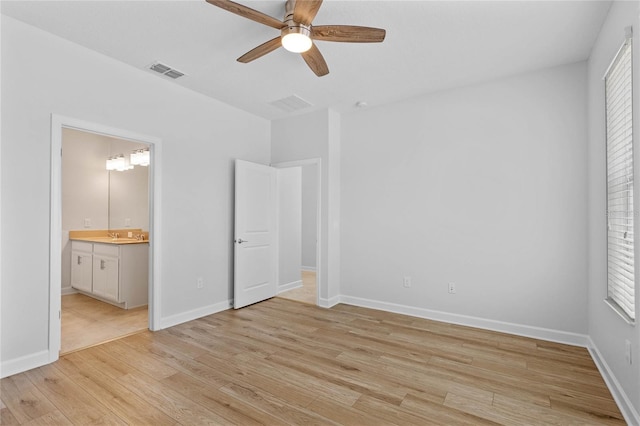 unfurnished bedroom with ceiling fan, light wood-type flooring, and connected bathroom