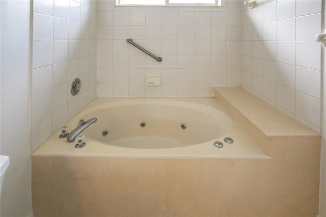 bathroom with a relaxing tiled tub