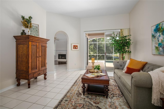 tiled living room featuring a tiled fireplace