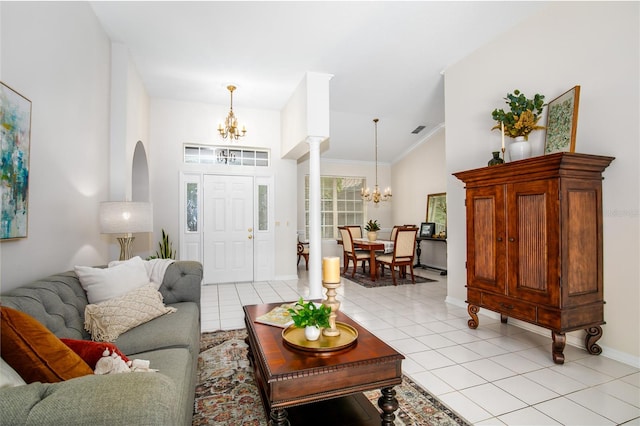 tiled living room with crown molding and a chandelier