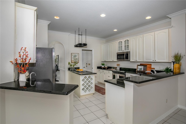 kitchen featuring kitchen peninsula, crown molding, white cabinets, light tile patterned floors, and appliances with stainless steel finishes