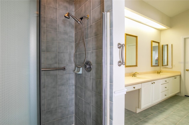 bathroom with vanity, walk in shower, and tile patterned flooring