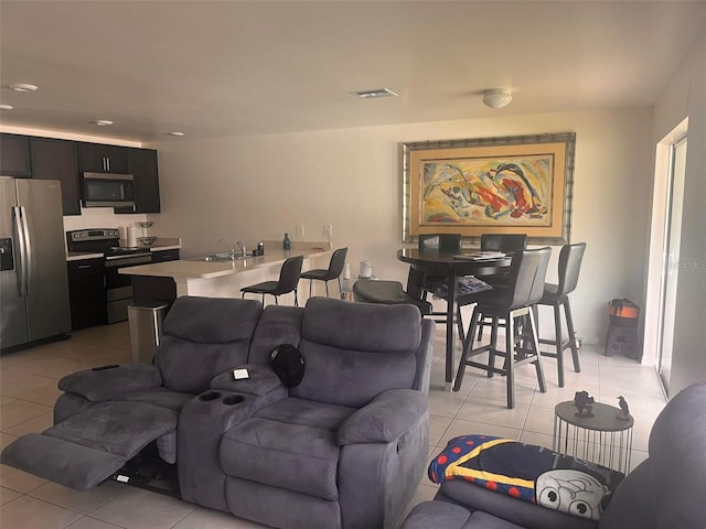 living room with light tile patterned flooring and sink