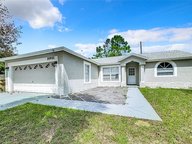 single story home with a front lawn and a garage