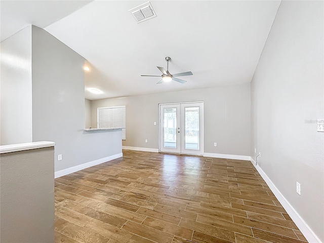 spare room featuring lofted ceiling, ceiling fan, french doors, and hardwood / wood-style flooring