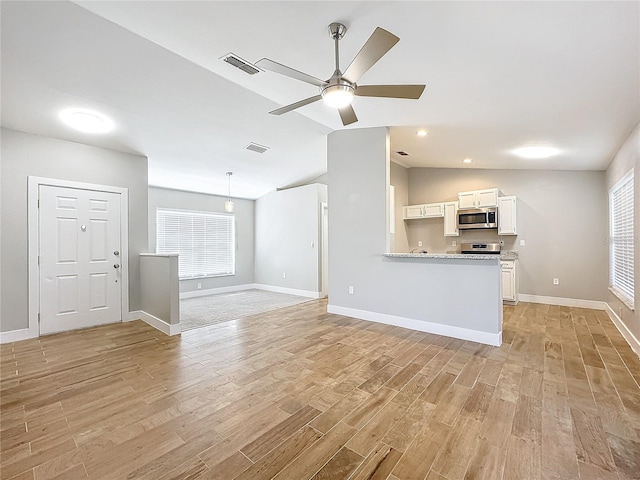 unfurnished living room with light hardwood / wood-style flooring, lofted ceiling, and ceiling fan