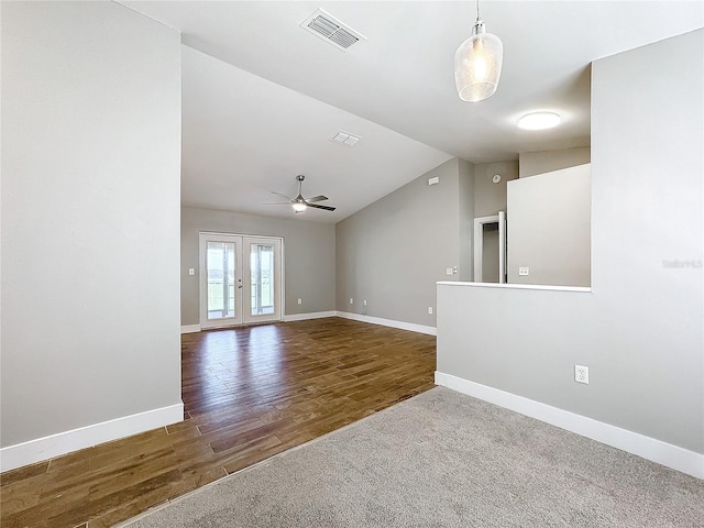 unfurnished room featuring french doors, vaulted ceiling, ceiling fan, and dark wood-type flooring