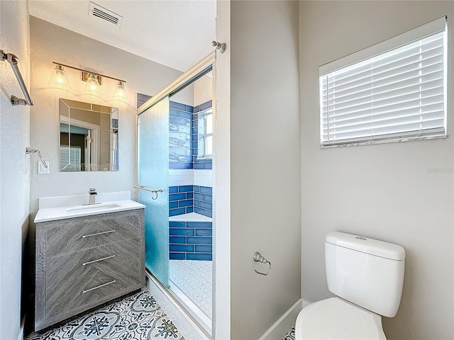 bathroom with vanity, toilet, and an enclosed shower