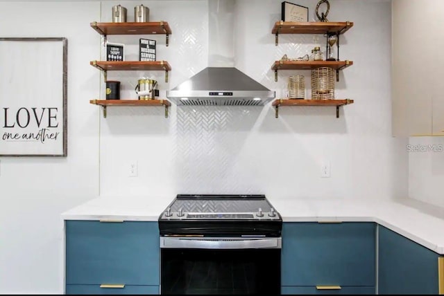 kitchen featuring blue cabinets, electric stove, and exhaust hood