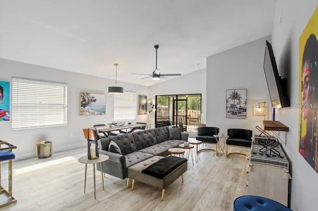 living room with light hardwood / wood-style floors, lofted ceiling, and ceiling fan