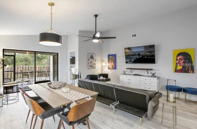 dining area featuring high vaulted ceiling, ceiling fan, and light hardwood / wood-style flooring