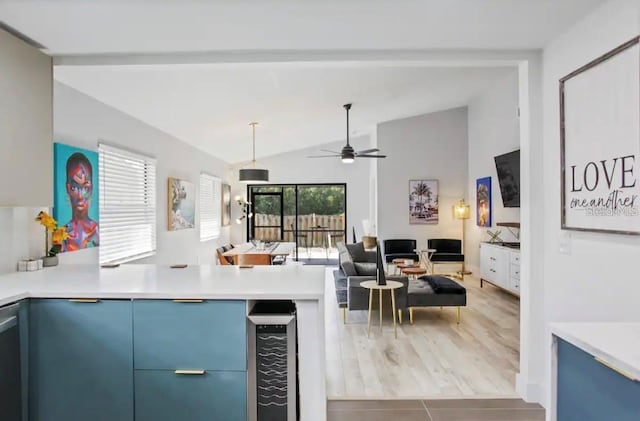 kitchen with blue cabinetry, lofted ceiling, beverage cooler, ceiling fan, and hardwood / wood-style flooring