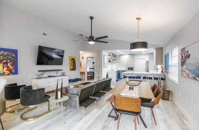 living room with ceiling fan and light hardwood / wood-style flooring