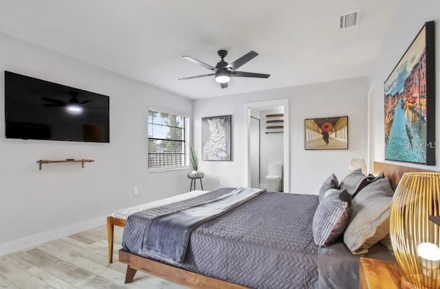 bedroom featuring light hardwood / wood-style flooring, ceiling fan, and ensuite bathroom