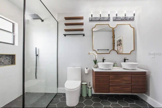 bathroom featuring tile patterned floors, a shower with shower door, vanity, and toilet