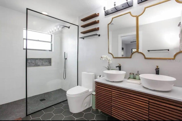 bathroom featuring a shower, tile patterned flooring, vanity, and toilet