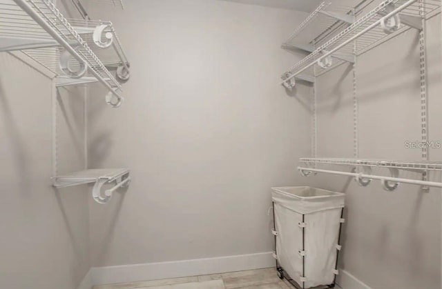 walk in closet featuring light hardwood / wood-style flooring