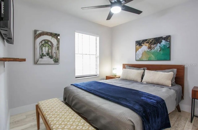 bedroom with ceiling fan and light hardwood / wood-style flooring