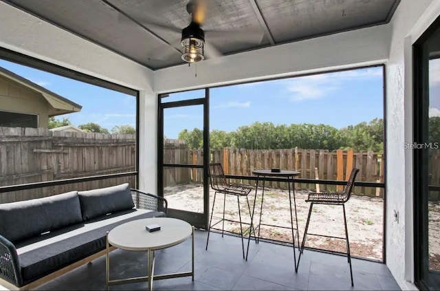 sunroom featuring ceiling fan