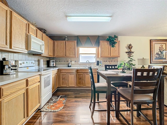 kitchen featuring sink, white appliances, a textured ceiling, backsplash, and dark hardwood / wood-style floors